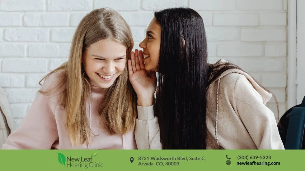 Person holding their ear due to pressure and fullness, evaluated at New Leaf Hearing Care