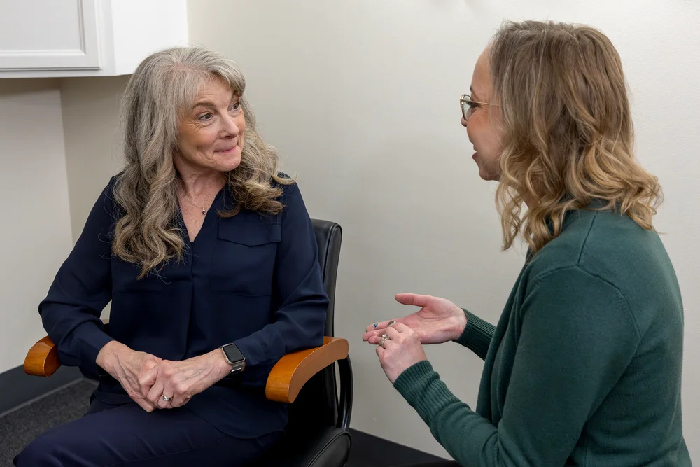 Audiologist discussing hearing care with an older patient